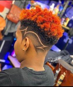 Fiery Orange Curly Haircut with Creative Side Design